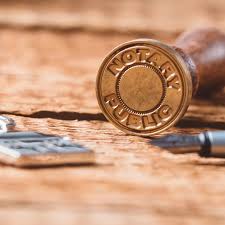 Notary Public seal on a wood desk